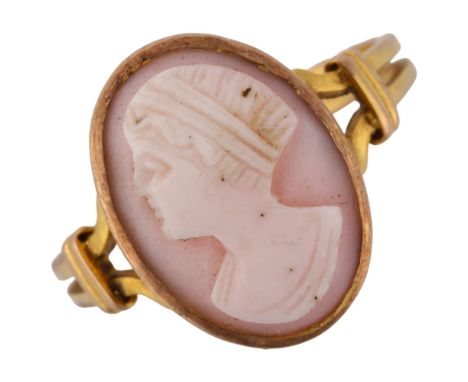 A pink coral cameo ring, unmarked gold settings with relief carved panel depicting female profile, setting height 16mm, size 
