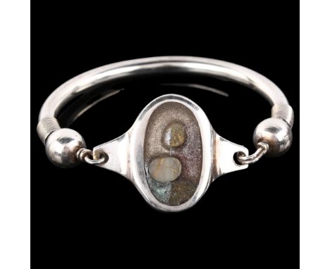 A Continental stone set glass torque bangle, unmarked silver settings, panel length 31.9mm, internal circumference 17cm, 47.8