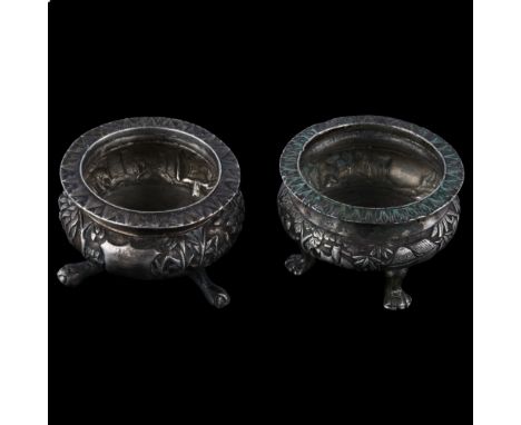 A pair of 19th century Chinese export silver salt cellars, circa 1860, by Hoaching, Canton, relief embossed village scenes, s