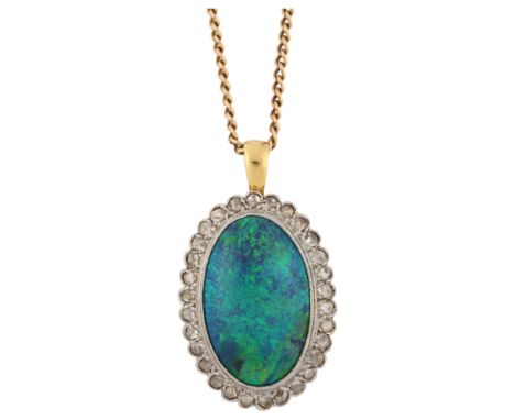 A fine black opal and diamond cluster pendant necklace, unmarked gold settings with 7ct oval double cabochon black opal and r
