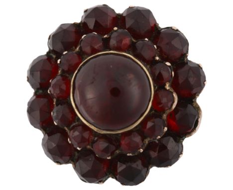 A 19th century Bohemian garnet cluster ring, unmarked gold closed-back settings with round cabochon and rose-cut garnets, set