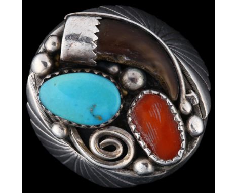 A large Native American sterling silver stone set ring, set with claw coral and turquoise, maker's marks ML, setting height 2