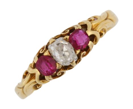 An early 20th century three stone ruby and diamond dress ring, unmarked gold settings with oval old-cut diamond, diamond meas