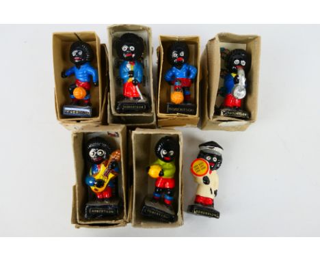 Seven vintage Robertson's advertising figures comprising musicians, footballers and lollipop man, predominantly contained in 