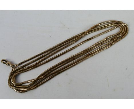A yellow metal, muff chain and clasp, stamped 9c, 156 cm (l), approximately 44 grams all in. [W]
