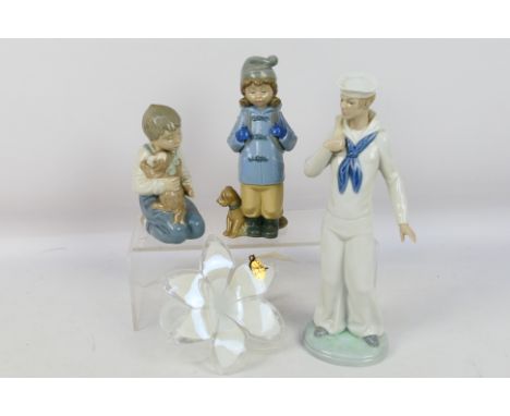 Lot comprising three Nao figures / groups, largest approximately 29 cm (h) and an Italian, Murano style glass flower. [W]