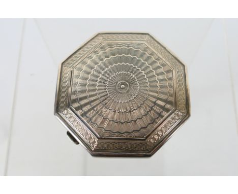 A silver powder compact of octagonal form having engine turned decoration to the cover, Birmingham assay, sponsors mark for C