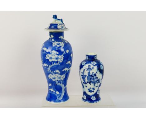 A Chinese blue and white jar and cover, decorated with prunus, vacant double circle mark to the base and one further blue and