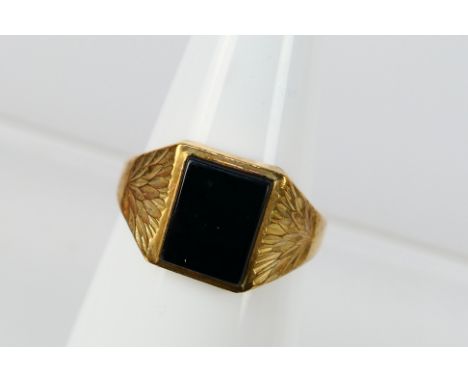 A 9ct yellow gold and onyx signet ring, size R, 3.1 grams. [W]