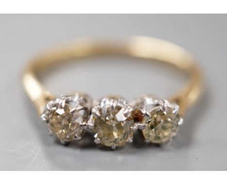 An 18ct and three stone diamond set ring, size P, gross weight 2.8 grams.