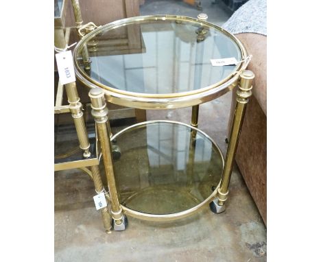A circular smoked glass and brass tray top two tier occasional table, diameter 57cm, height 64cm