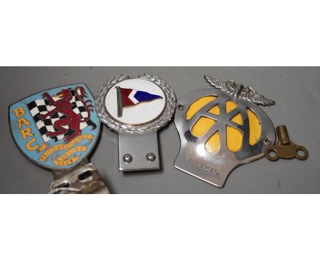 A British Automobile Racing Club car badge, an AA badge and one other