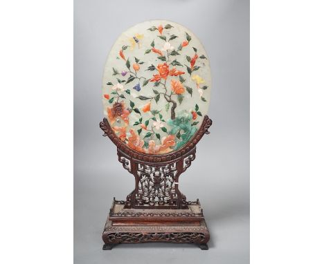 An early 20th century Chinese carved hardstone table screen with pierced hardwood stand  Height 44cm Width 21cm