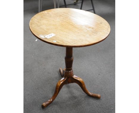 A George III circular oak tripod tilt top tea table on turned column, diameter 58cm, height 67cm