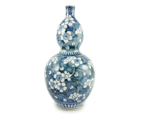 A Japanese blue and white 'prunus' double gourd sake flask, late Edo period, height 32cms  31.5cm high