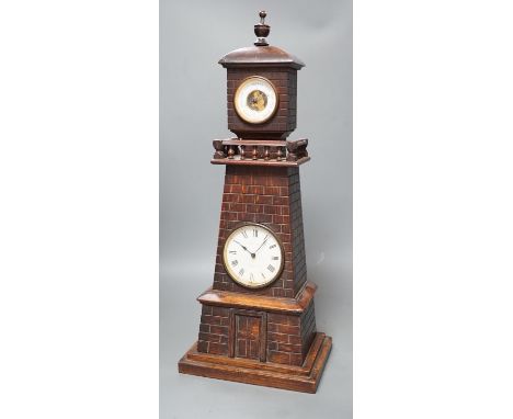 A late Victorian carved oak 'lighthouse' combined mantel timepiece and barometer, signed Frank Flower, St James' St, S.W,  He