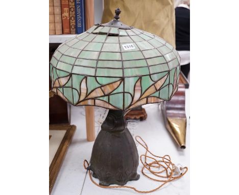 A spelter lamp with Tiffany style shade, 57cms high including shade