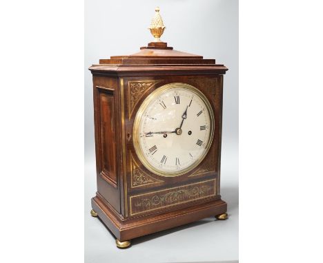 A Regency brass inlaid mahogany bracket clock, with pineapple finial, bears interior paper label Cuss &amp; Co. 49cm high