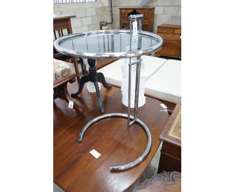 In the style of Eileen Gray - An E 1027 style circular chrome and smoked glass telescopic occasional table, diameter 51cm