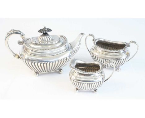 A late Victorian silver three-piece tea set, comprising teapot, sugar and cream, each piece of half-gadrooned shaped rectangu