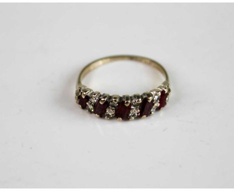 An 18ct white gold, ruby and diamond half hoop eternity ring, comprising five rectangular cut rubies diagonally set alternati