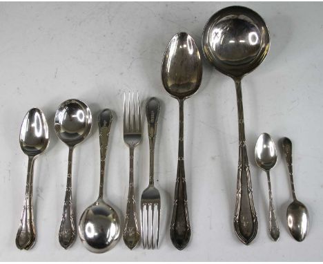 A Walker &amp; Hall silver part cutlery suite, each piece having crested terminal, comprising four table spoons, 24 table for