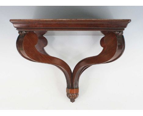 A mahogany clock bracket in the early Victorian taste, being highly polished, having two downswept supports with single fluti