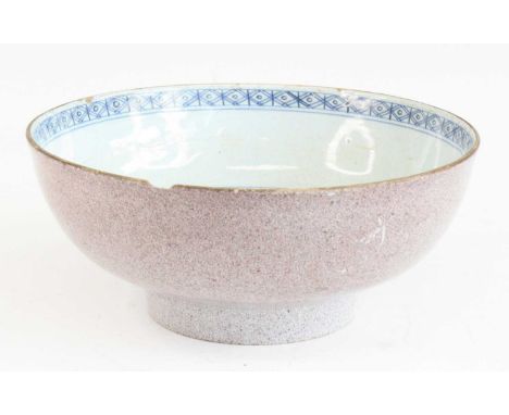 A Lambeth delftware bowl, 18th century, the well decorated with a flower within a diaper border, the exterior with a powdered