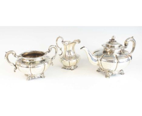 A Victorian silver three-piece tea set, comprising teapot, cream jug and sugar bowl, each piece of melon form with applied fl