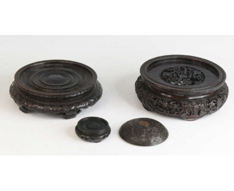A Chinese hardwood vase stand, 19th century, profusely carved with flowers and standing upon five ruyi head feet, dia.22cm, t