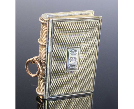A George IV silver vinaigrette, in the form of a book, the engine turned cover with monogrammed cartouche opening to reveal a