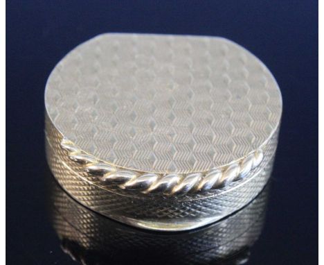 An Elizabeth II 9ct gold pill box, of semicircular form, having all-over engine turned decoration with rope-twist catch, make