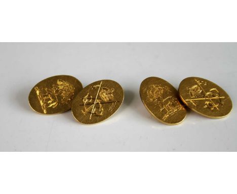A pair of yellow metal oval double ended cufflinks, one link engraved with a crown and two crossed spears, the other link dep