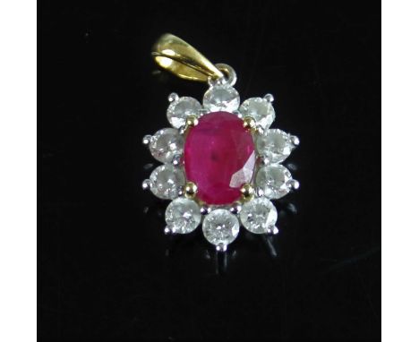 An 18ct yellow and white gold, ruby and diamond oval cluster pendant, featuring a centre oval faceted ruby within a border of