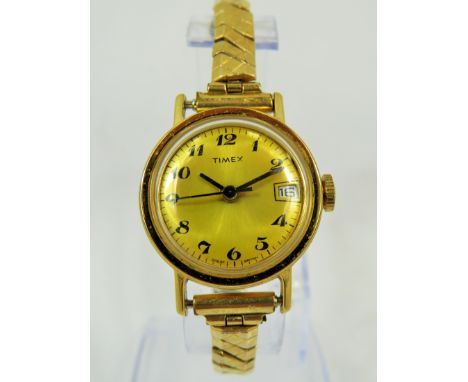 Timex Mechanical watch with Date window with expanding gold tone strap. Runs welll. See photos.
