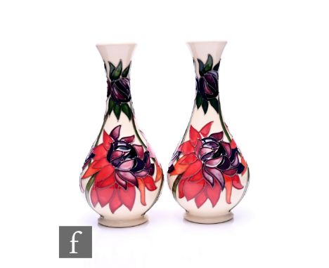 Emma Bossons - Moorcroft Pottery - Two 'Ruby Red' vases, circa 2017, of baluster form, tube line decorated with brilliant col