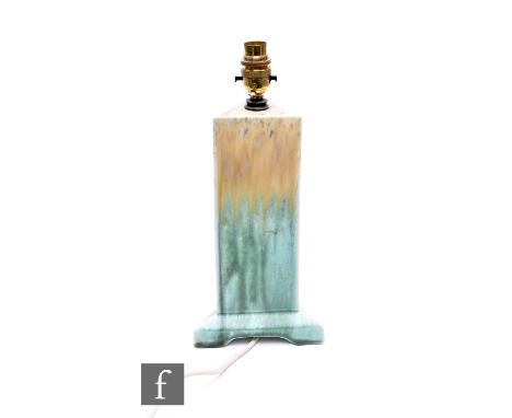 Ruskin Pottery - A crystalline lamp base of triangular form, the column glazed in a streaked pale ochre to green, raised on g
