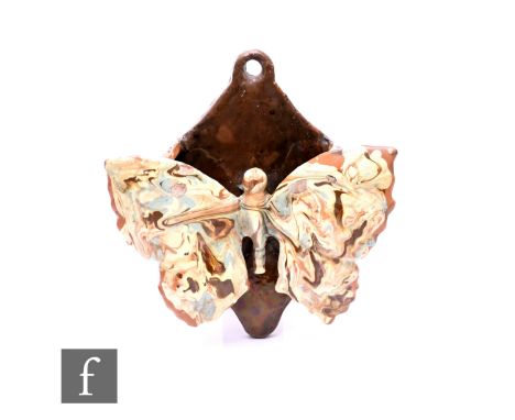 C H Brannam - A Barum ware wall pocket in the form of a butterfly with outstretched wings with mottled agate slip glaze, inci