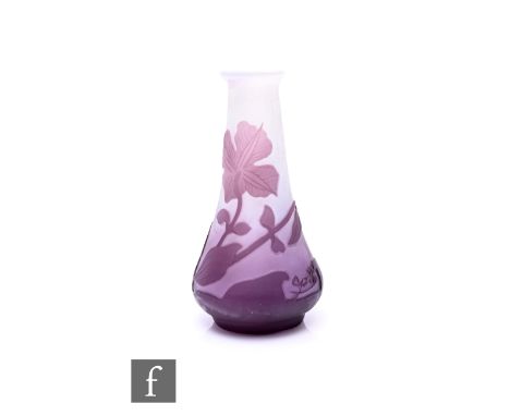Emille Galle - A miniature cameo glass posy vase of low shouldered form with a slender tapered neck, cased in amethyst over c