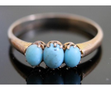 A yellow metal ring set with three turquoise cabochons, marks indistinct, gross wt. 1.5g, size M.