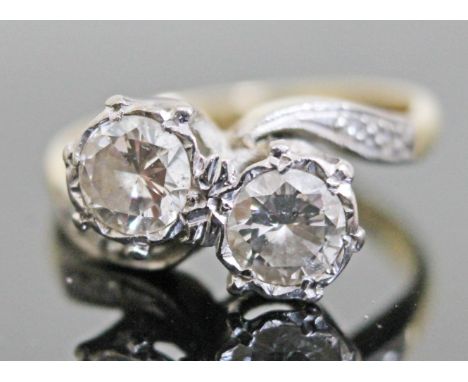 An Art Deco diamond crossover ring, each diamond weighing approx. 0.50 carats, diamond set shoulders, band indistinctly marke