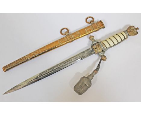 A Nazi Naval Officer's dress dagger with plastic wire bound grip, gilt brass eagle and swastika pommel, double edged and etch