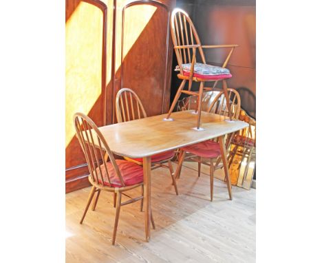 An Ercol elm and beech table and four chairs, table length 153cm, depth 76cm & height 71cm.