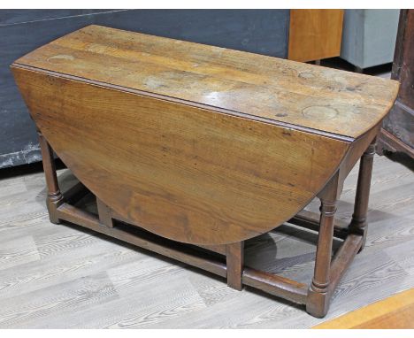 An 18th Century oak gate leg table, length 129cm, min. depth 50cm & height 68cm.