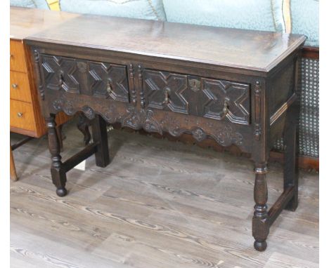 A 1920s geometric oak two drawer dresser base or side table, length 114cm, depth 42cm & height 81cm.