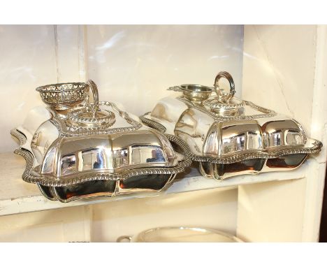 A pair of Elkington and Co silver plated tureens and covers, rectangular form with gadrooned serpentine borders, removable ha