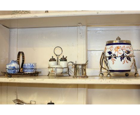 A Victorian silver mounted ceramic biscuit barrel on plated stand, mark of Taylor and Tunnicliffe, a three piece ceramic crue