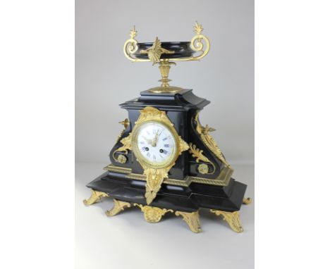 A French Empire style ormolu gilt metal mounted black slate mantel clock with vase surmount, 4 inch white enamel dial with Ro