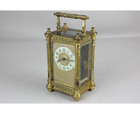 A French gilt metal carriage clock with enamel chapter ring, in decorative case with column corners, 15cm high