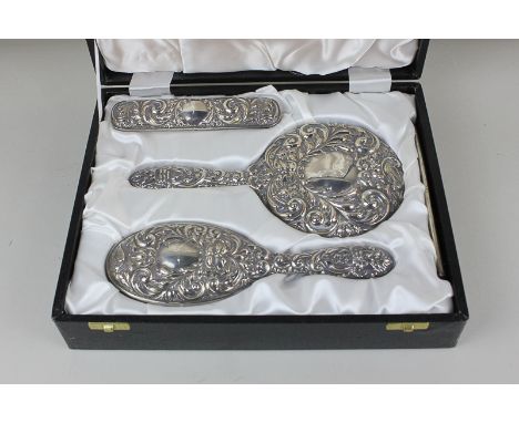 An Elizabeth II silver mounted dressing table set of hair brush, clothes brush, comb and hand mirror, maker W I Broadway & Co
